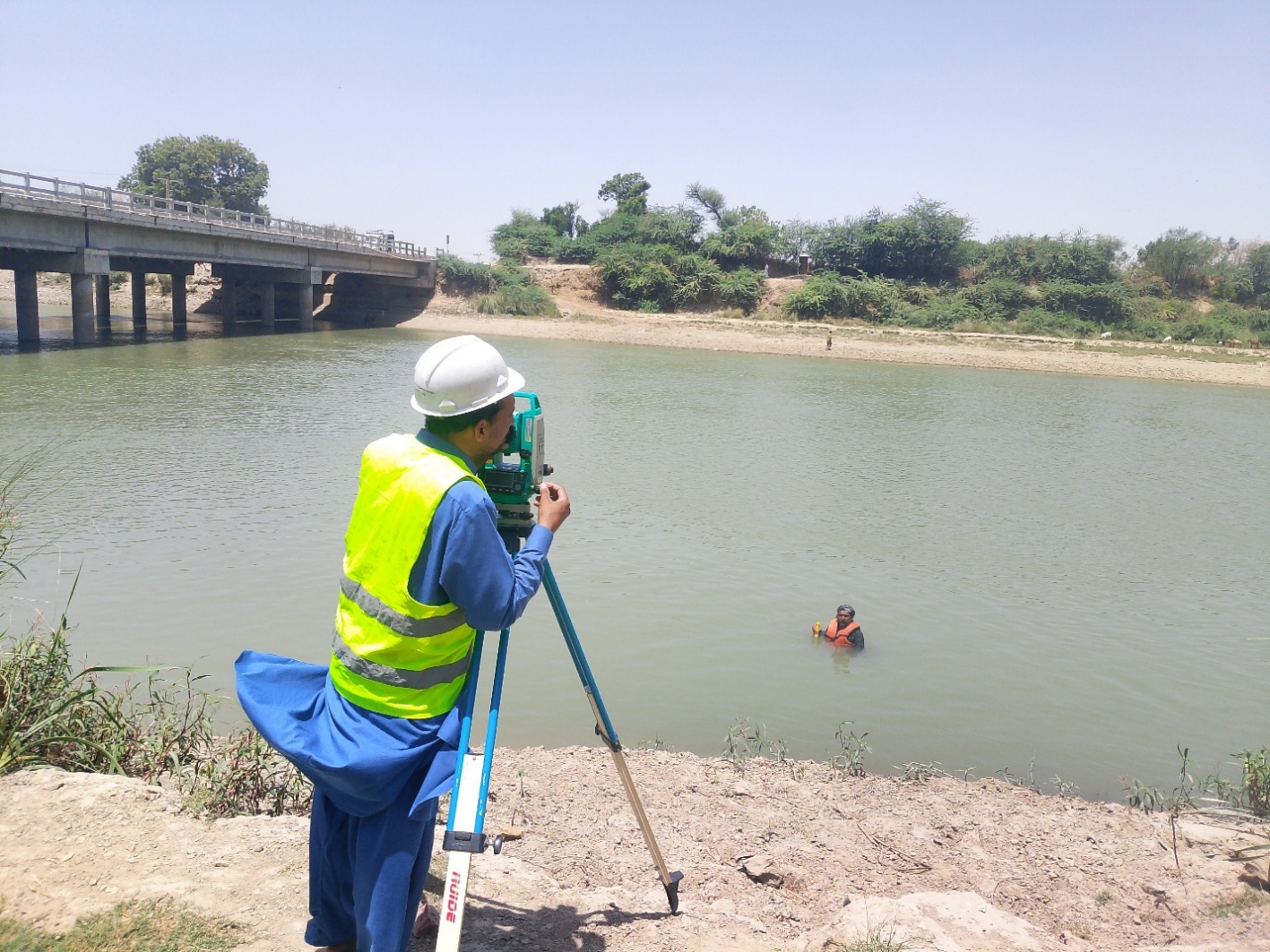 Field survey team at a river bridge